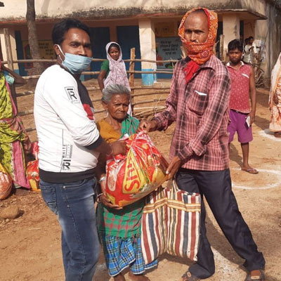 RCRC members distributing relief in a village